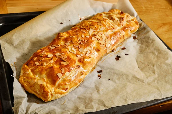 Tasty fresh hot apple strudel on baking tray