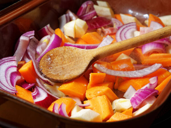Preparing carrot, parsley and red onion on cooking pot