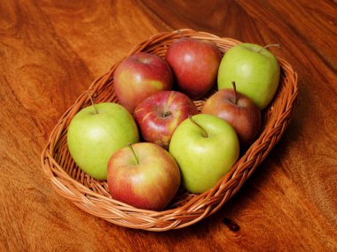 Ahşap masada yeşil ve kırmızı elma meyveleriyle dolu bir hayat