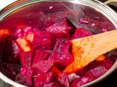 Preparing tasty beetroot soup in cooking pan