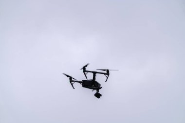 Chicago, IL - March 11th, 2023: Hulu hires drone operators to fly and gather footage during the annual St. Patrick's day river dyeing event. clipart