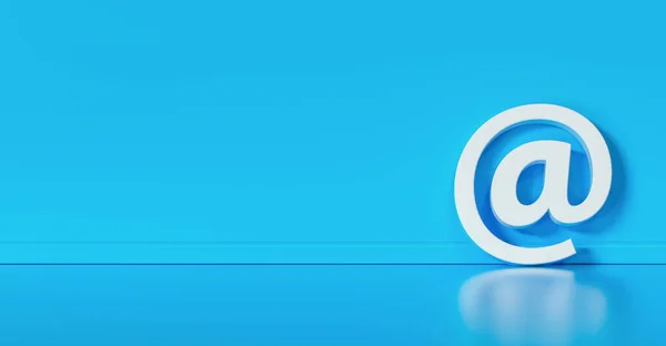 stock image Email Icon or at sign leaning against a blue wall as a communication concept, copyspace for your individual text. 