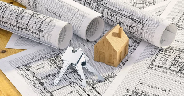 Keys with toy house and architectural plans