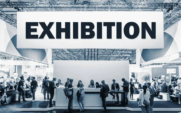 stock image Crowd of people at a trade show booth with a banner and the text Exhibition.