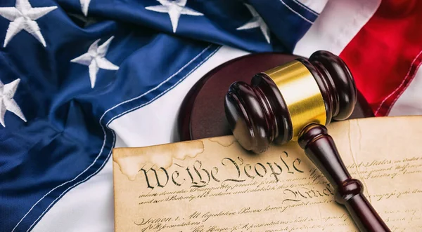 stock image American flag with US constitution and a judge's gavel symbolizing the American justice system or the Judicial Branch of government