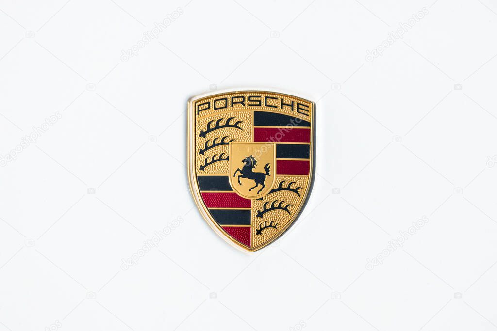 AACHEN, GERMANY MARCH, 2017: Porsche Sign Close Up on a white car. Ferdinand Porsche founded the company in 1931 with main offices in the centre of Stuttgart.