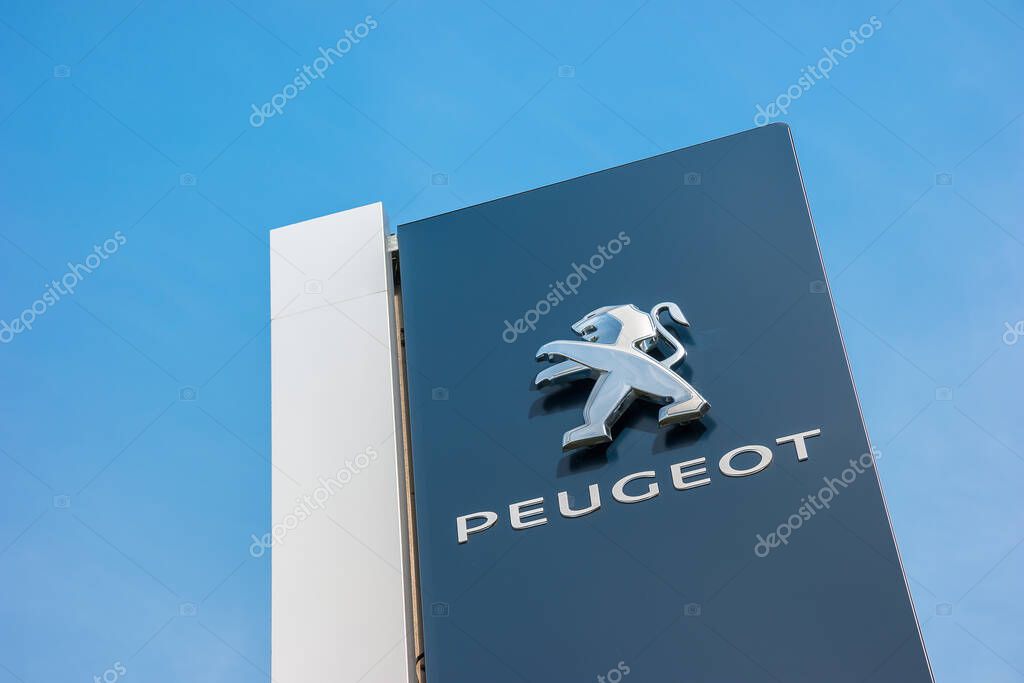 BAESWEILER, GERMANY MARCH, 2017: Peugeot dealership sign closeup against blue sky. Peugeot is a French automobile manufacturer and part of Groupe PSA.