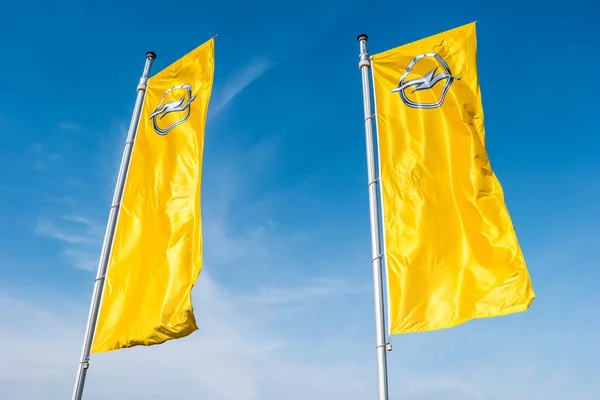 stock image AACHEN, GERMANY MARCH, 2017: Opel flags against blue sky at the Opel Store. Opel AG is a German automobile manufacturer.