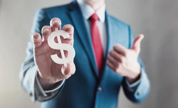 Businessman Holding Dollar Sign Thumb — Stock Photo, Image