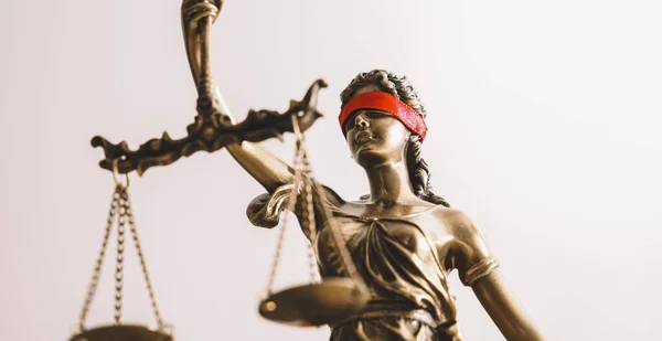 The Statue of Justice - lady justice or Iustitia / Justitia the Roman goddess of Justice with red blindfold, banner size, copyspace for your individual text.