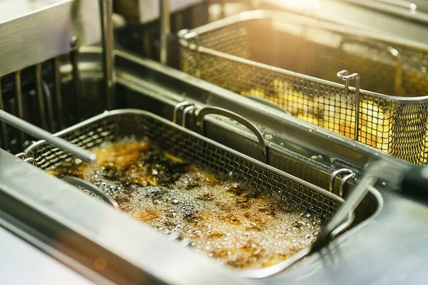 stock image Delicious French fries are taken out from hot oil.