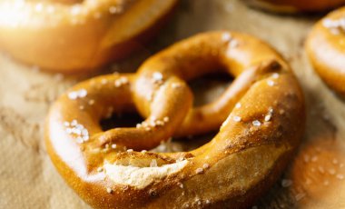 Fresh pretzels on baking paper, Bavarian homemade traditional food clipart