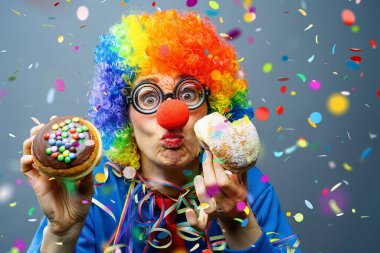 Girl at German Fasching Carnival eating doughnut-like traditional pastry, confetti Falling in colorful colors clipart