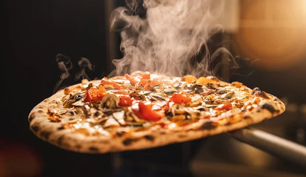 stock image traditional italian pizza from the stone oven with fresh steam in the italian pizzeria