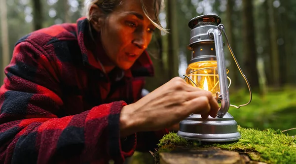 stock image Female Hiker looking a kerosene lamp or oil lamp in the forest. authentic close-up shot. Travel concept image