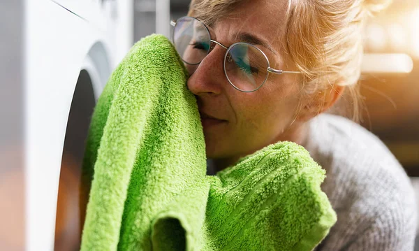 Γυναίκα Στις Δουλειές Του Σπιτιού Μυρίζει Φρέσκα Ρούχα Από Στεγνωτήριο — Φωτογραφία Αρχείου
