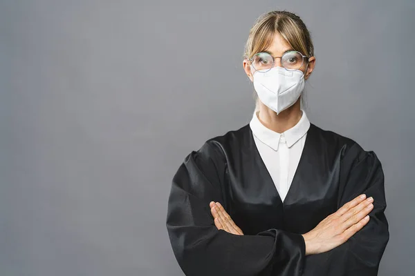 Lawyer or judge wearing N95 FFP2 an anti virus protection mask to prevent others from corona COVID-19 and SARS cov 2 infection. Law and justice concept image