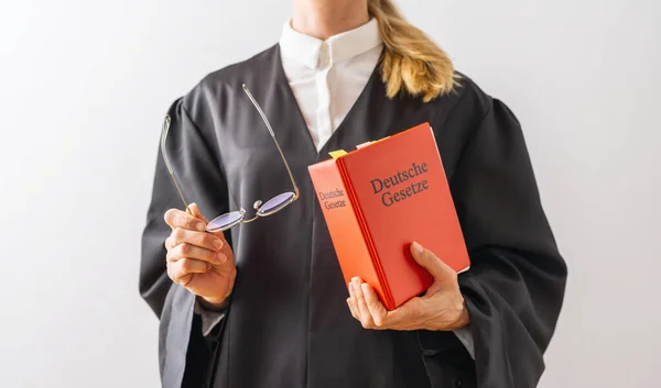 Deutsche Gesetze (German for: German laws ) German Lawyer with civil law code in a court room