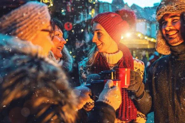 Cheerful Friends Enjoying Mulled Wine Hot Chocolate Snowy Christmas Market Royalty Free Stock Images