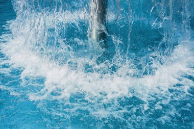 Yüzme havuzundaki şelale mantarına yakın çekim bir otelde eğlence için büyük bir sıçrama yaratıyor.