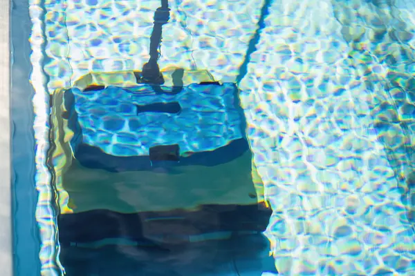 robot pool cleaner. Pool maintenance with automatic robot. cleaner the bottom of the pool and walls with a submersible robot. Summer pool cleaning robot before swimming. vacuum cleaner