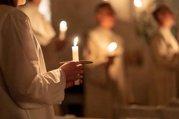 Image of People handling candles in the hands. Christmas and lucia holidays