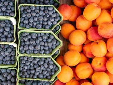 Yaban mersini ve taze turuncu şeftalili karton kutular.