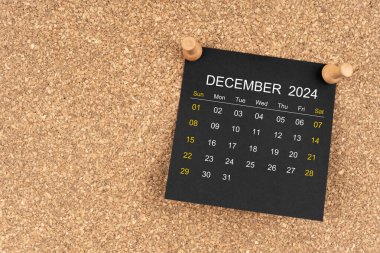 Aralık 2024 için tahta raptiyeli siyah takvim sayfası.