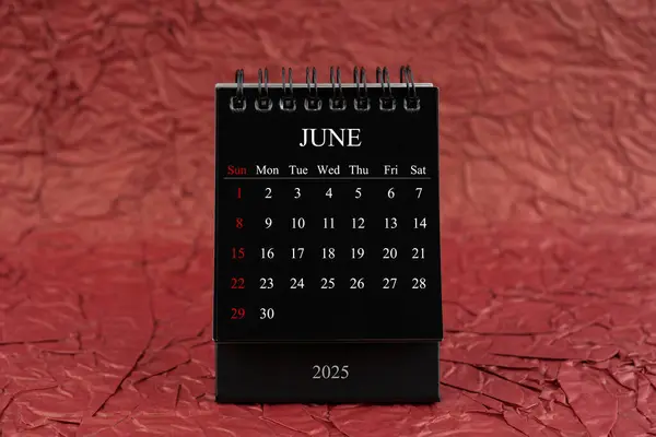 June 2025 Front View Black Desk Calendar Crumpled Red Paper — Stock Photo, Image