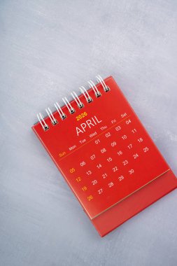 Nisan 2026 Ahşap mavi arkaplanda kırmızı renk takvimi.
