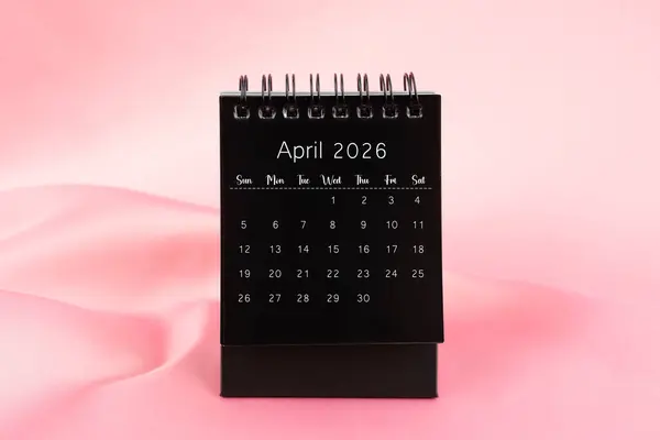 Black Desk Calendar April 2026 Pink Color Silk Textile Background — Stock Photo, Image