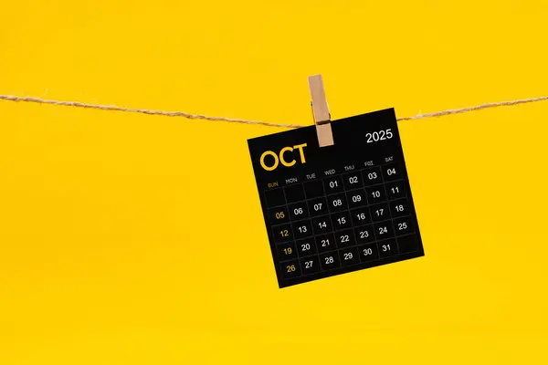 October 2025 Black Calendar Hanged Brown Rope Yellow Background — Stock Photo, Image