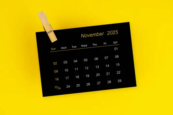 November 2025 Black Calendar Wooden Clip Yellow Color Background — Stock Photo, Image