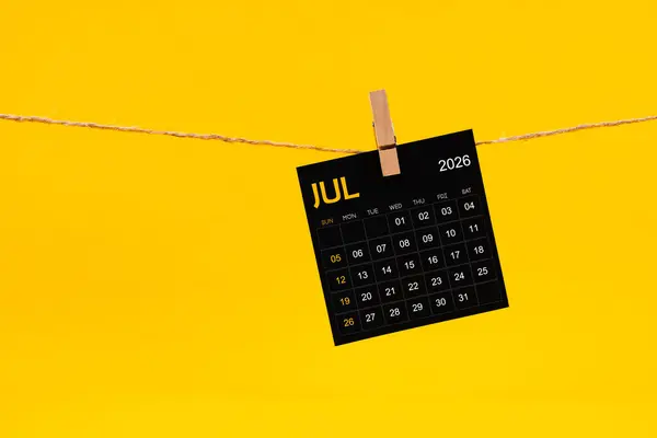July 2026 Black Calendar Hanged Brown Rope Yellow Color Background — Stock Photo, Image