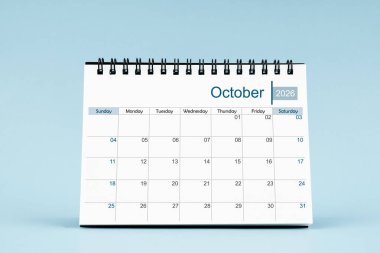 Yumuşak mavi arka planda 2026 yılı için Ekim 2026 aylık masa takvimi.