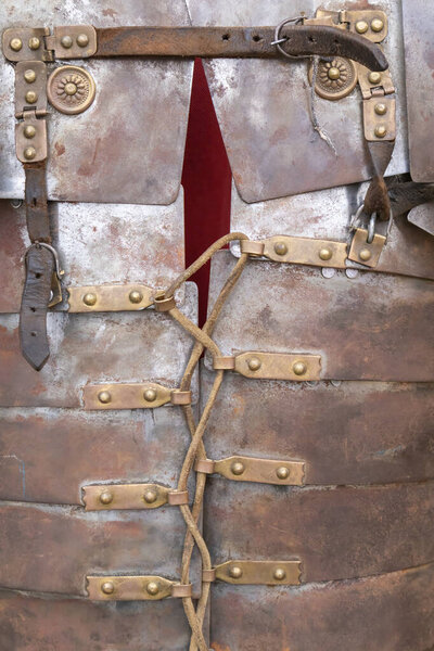 Foreground detail photography in vertical view of armor af a soldier froma ancient roman empire, lorica segmentata