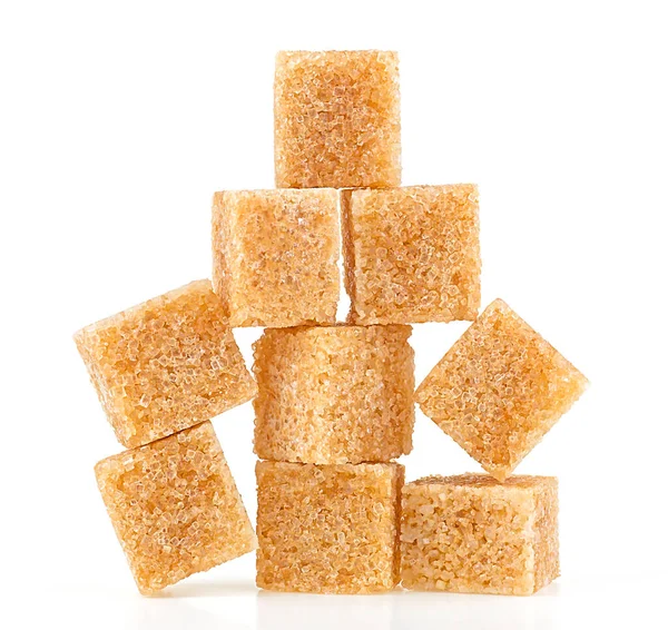 stock image Pile of brown cane sugar cubes isolated on a white background. Pyramid.