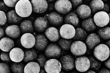 Group of frozen cherries as background, top view. Black and white image.