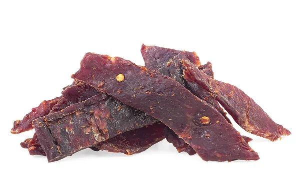 Beef jerky pieces isolated on a white background. Pile of spiced jerky.