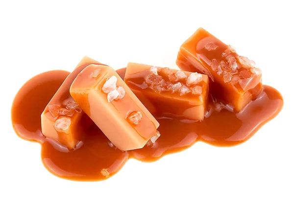 Caramel sauce and caramel candies with sea salt isolated on a white background