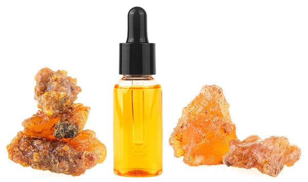 Bottle of essential oil with frankincense resin isolated on a white background. Olibanum aromatic resin. Incense and perfumes.