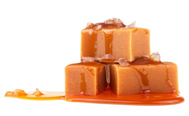 Karamel soslu lezzetli şekerler ve beyaz arka planda izole edilmiş deniz tuzu.