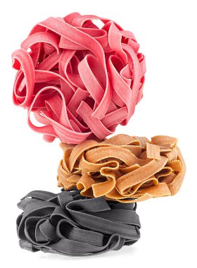 Beyaz arka planda izole edilmiş farklı renkli makarna yuvaları. İtalyan makarna tagliatelle.