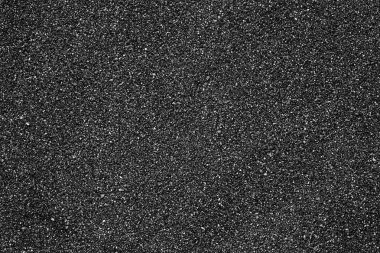 Arka plan olarak siyah kum plajı dokusu, üst manzara. Volkanik kum arkaplanı.