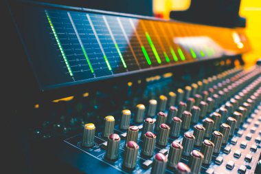 VU meter on audio mixing console meter bridge and knobs. Recording, broadcasting concept. Music background