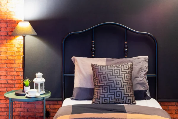 modern classic black iron bed headboard on black blinds in loft style bedroom