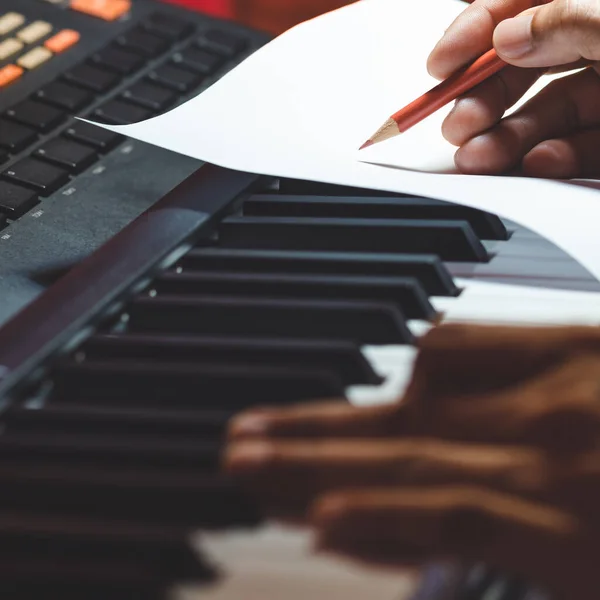 Close Songwriter Hand Writing Hit Song Music Sheet While Playing Stock Image