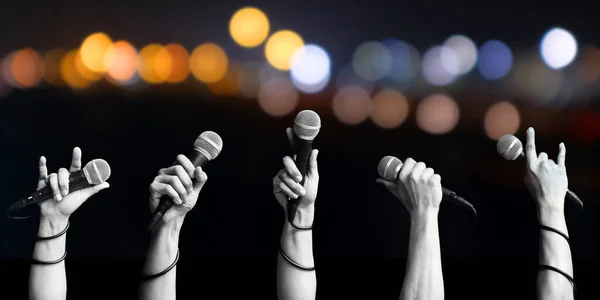Close Microphone Hands People Blurred Colorful Light Concept Voice People Royalty Free Stock Images