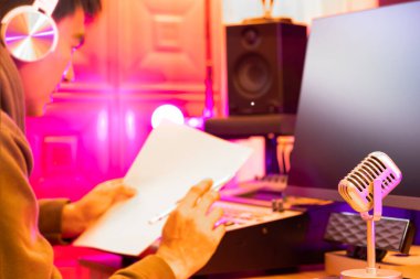 Stüdyoda çalışan Asyalı erkek ses sanatçısı, mikrofona odaklan. konsept üzerinde ses