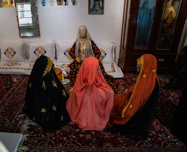 Doha, Qatar - December 13, 2024: Qatar National Day celebrations Statues of Qatari women sitting in a majlis at the Qatari House in Darb Al Saai